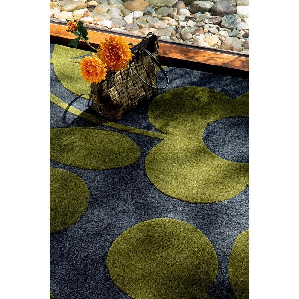 Orla Kiely Sprig Stem Marine Designer Rug featuring circular pattern in olive green and navy on dark blue background, hand-tufted wool