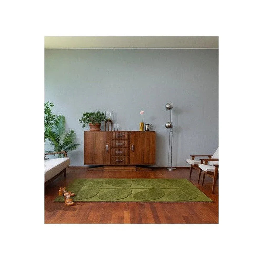Orla Kiely Solid Stem Fern Rug featuring leaf pattern in olive, sage and moss on light grey background, machine-woven wool