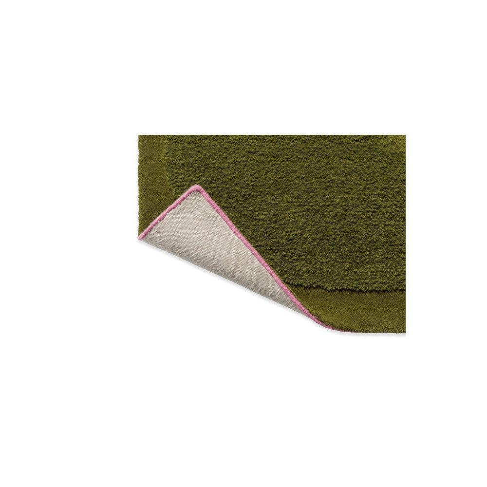 Orla Kiely Solid Stem Fern Designer Rug featuring botanical stem-fern pattern in olive green with pink edge on beige underside, hand-tufted wool