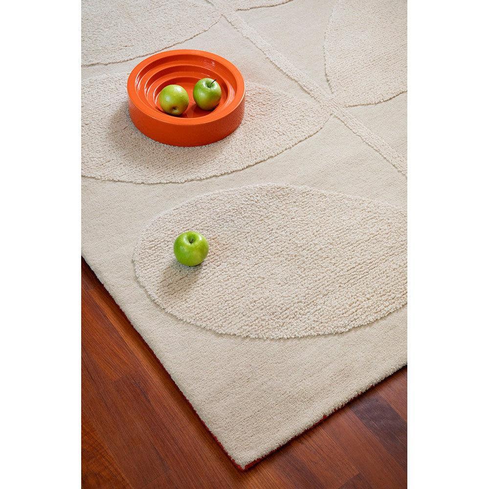 Orla Kiely Solid Stem Ecru Designer Rug featuring stem pattern in cream and beige on warm wood floor, hand-tufted wool