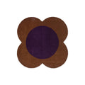 Orla Kiely Flower Spot Rug featuring flower-shaped brown petals with a deep violet center on white background