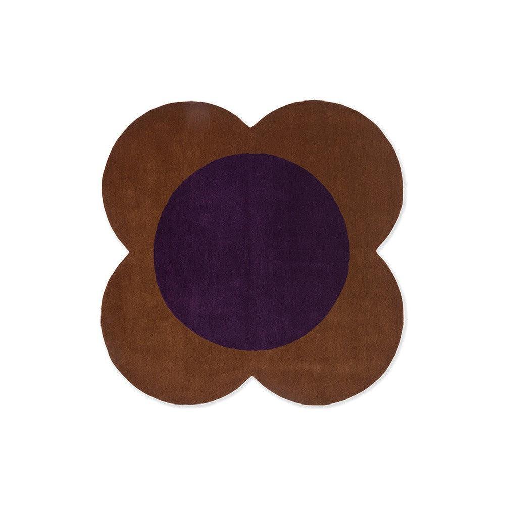 Orla Kiely Flower Spot Rug featuring flower-shaped brown petals with a deep violet center on white background