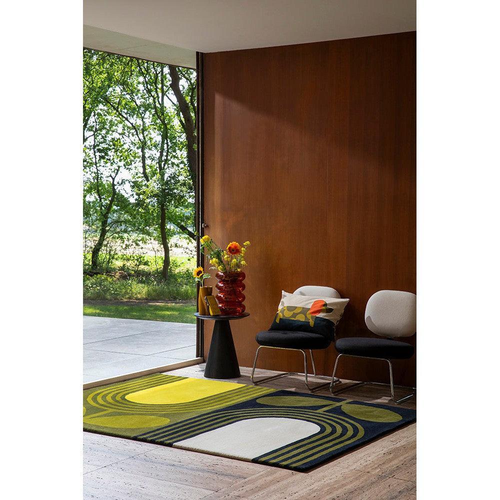 Orla Kiely Striped Tulip Seagrass Rug featuring abstract tulip pattern in yellow, lime, navy and cream on natural wood floor, hand-woven seagrass