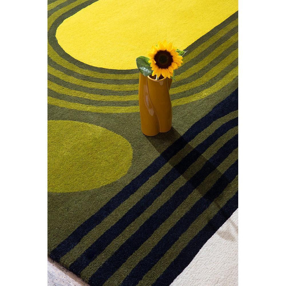 Orla Kiely Striped Tulip Seagrass Rug featuring bold yellow, lime green, olive green and navy stripes on cream background, hand-tufted wool