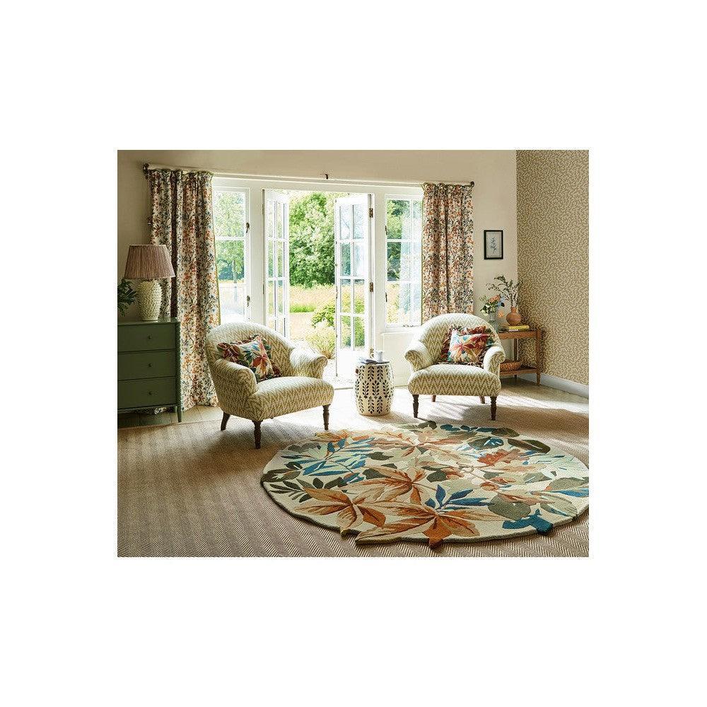 Sanderson Robin's Wood Russet Round Rug featuring botanical leaf pattern in rust, teal, sage on cream background, hand-tufted wool