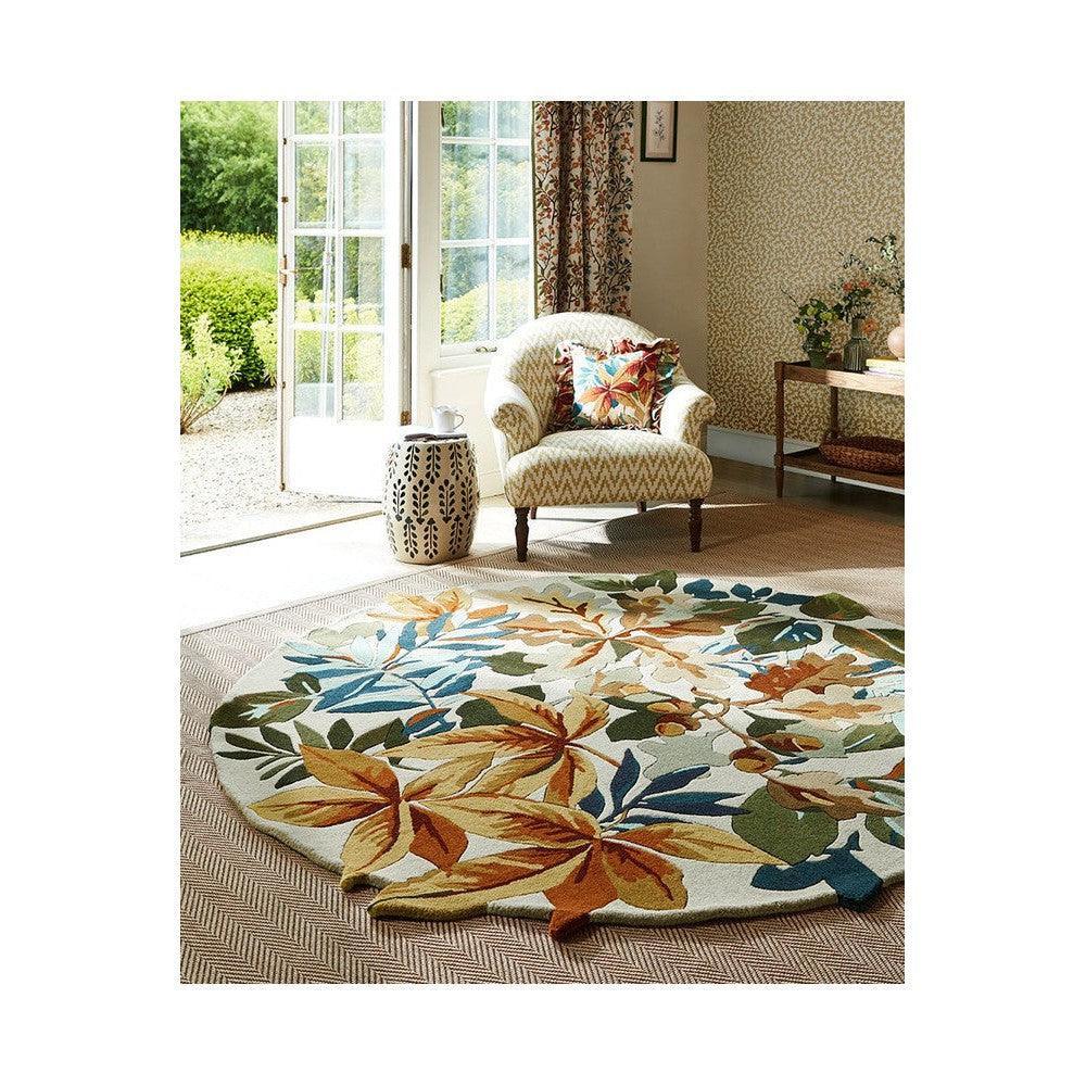 Sanderson Robin's Wood Russet Round Brown Designer Rug featuring botanical leaf pattern in russet, ochre, emerald, teal and cream on cream background, hand-tufted wool