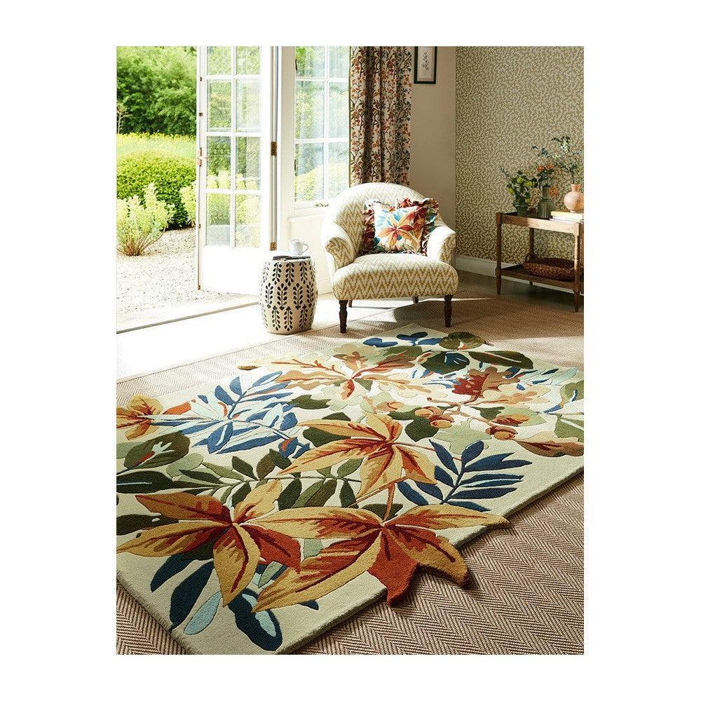 Sanderson Robin's Wood Russet Brown Designer Rug featuring botanical leaf pattern in russet brown, burnt orange, olive green, teal and navy on cream-beige background, hand-tufted wool