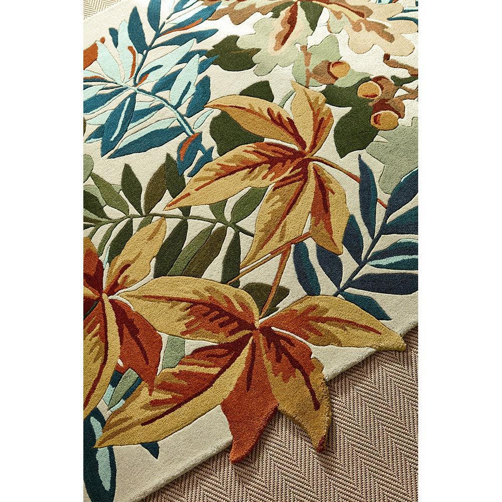 Sanderson Robin's Wood Russet Brown Designer Rug featuring botanical leaf pattern in russet brown, ochre, olive green, teal on cream background, hand-tufted wool