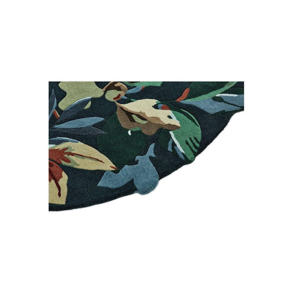 Sanderson Robin's Wood Round Rug featuring botanical pattern in forest green, cream, rust, blue on dark navy background, hand-tufted wool