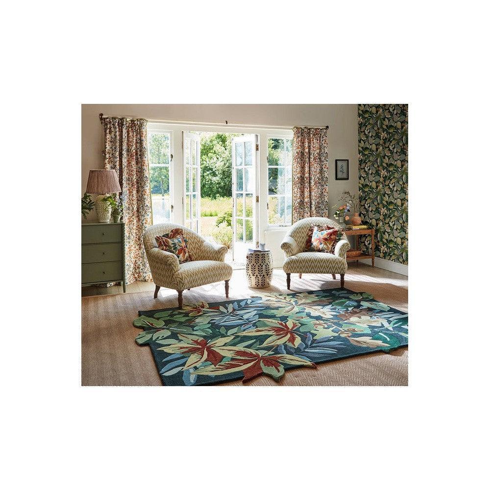 Sanderson Robin's Wood rug featuring botanical leaf pattern in forest green, teal, ivory and red on cream background, hand-tufted wool