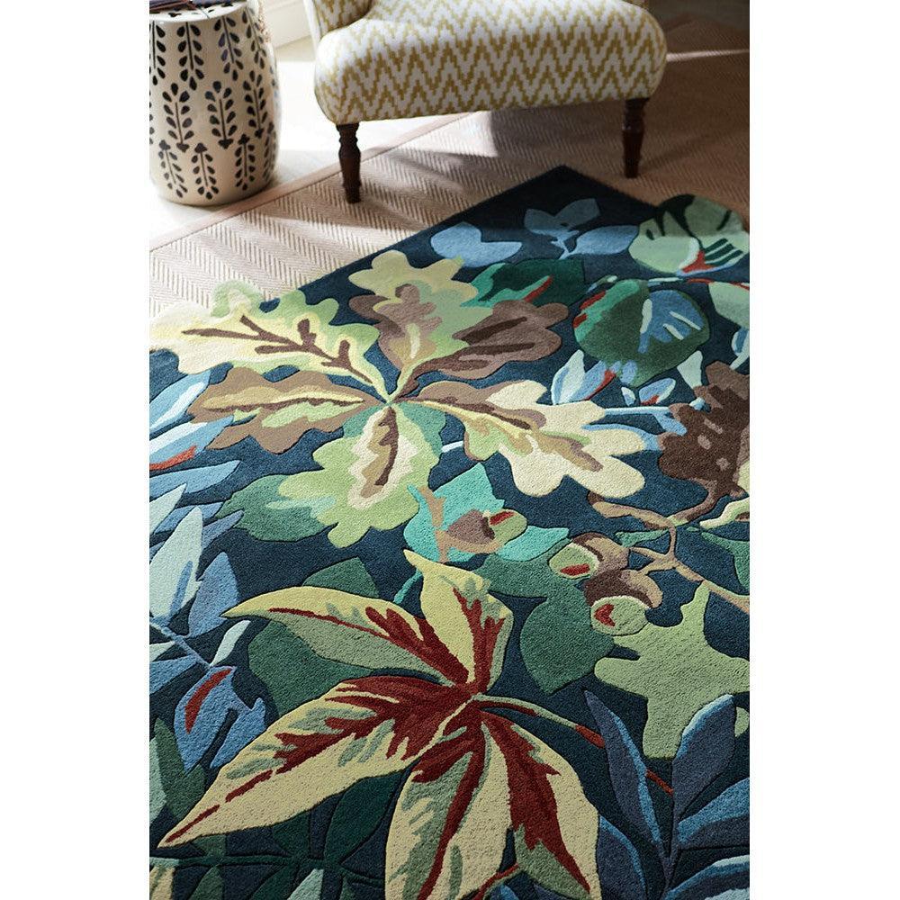 Sanderson Robin's Wood Forest Green Rug featuring botanical leaf pattern in forest green, teal, lime and cream on navy background, hand-tufted wool