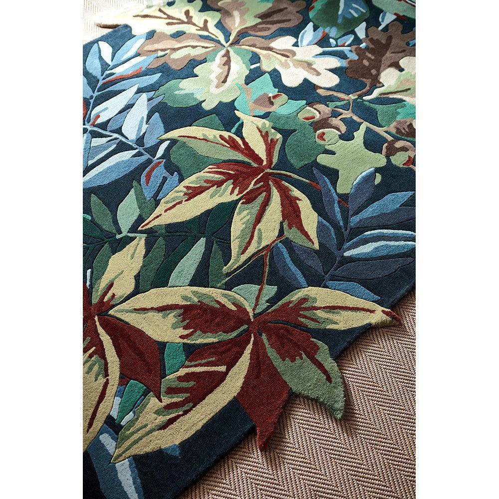Sanderson Robin's Wood rug featuring botanical leaf pattern in forest green, emerald, teal and burgundy on navy background, hand-tufted wool