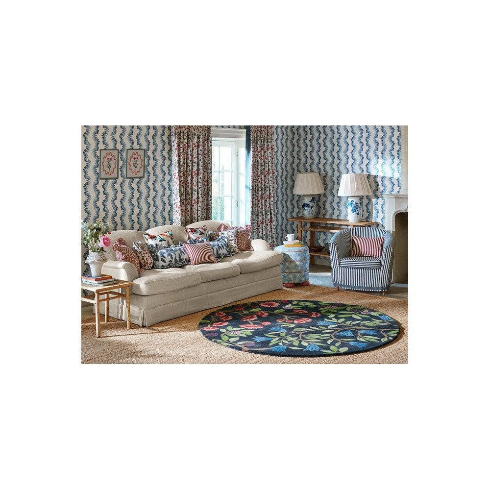 Sanderson Foraging Indigo Round Rug featuring botanical pattern in indigo, emerald, pink, red on navy background, hand-tufted wool