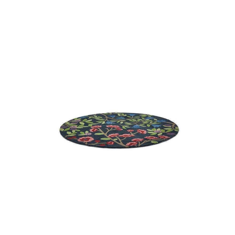 Sanderson Foraging Indigo Round Rug featuring botanical floral pattern in emerald green, pink and red on indigo background, hand-tufted wool