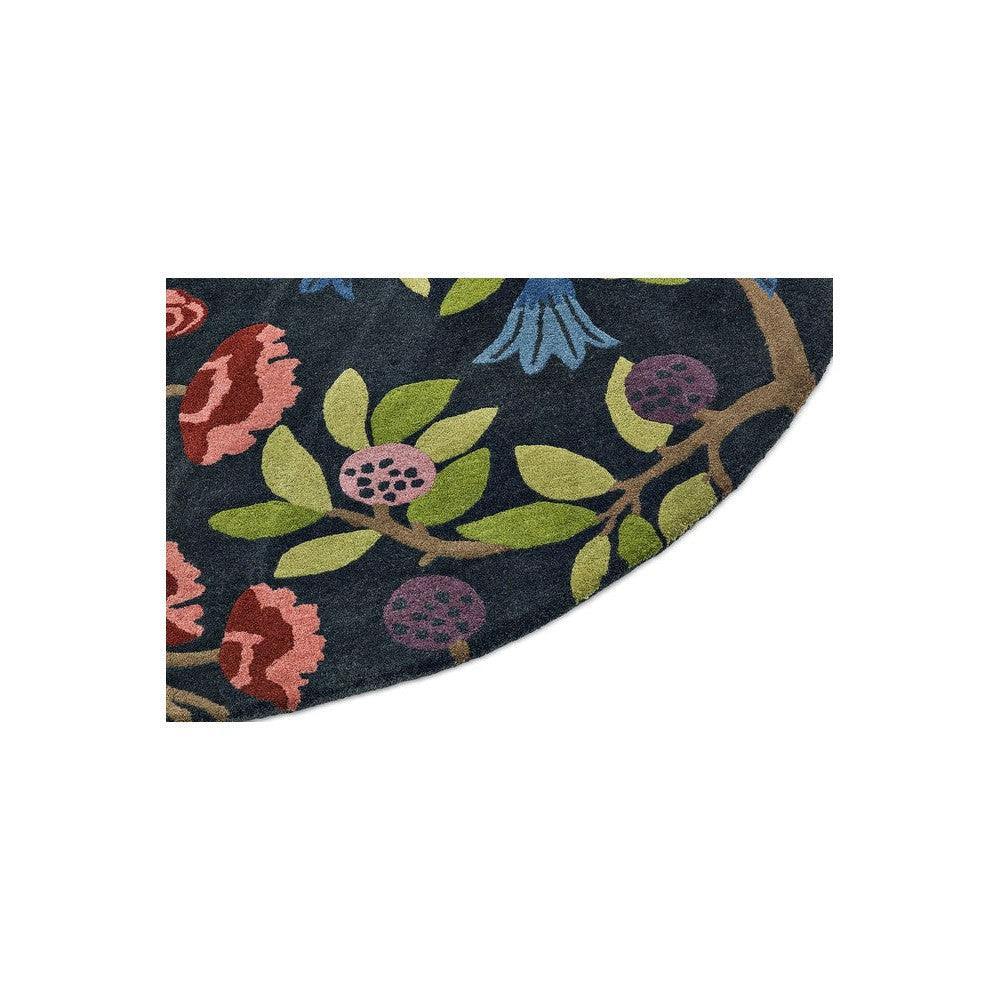 Sanderson Foraging Indigo Round Designer Rug featuring floral motif in navy, emerald green, pink, burgundy on deep indigo, hand-tufted wool