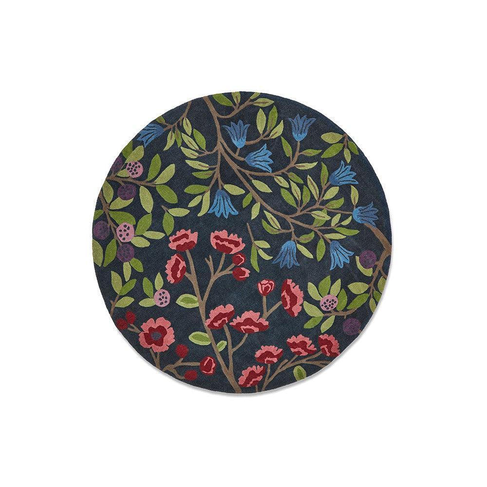 Sanderson Foraging Indigo Designer Rug featuring botanical floral pattern in navy, royal blue, pink, green on indigo background, machine-made wool