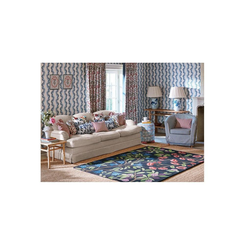 Sanderson Foraging Indigo Designer Rug featuring floral pattern in navy, indigo, pink and green on dark background