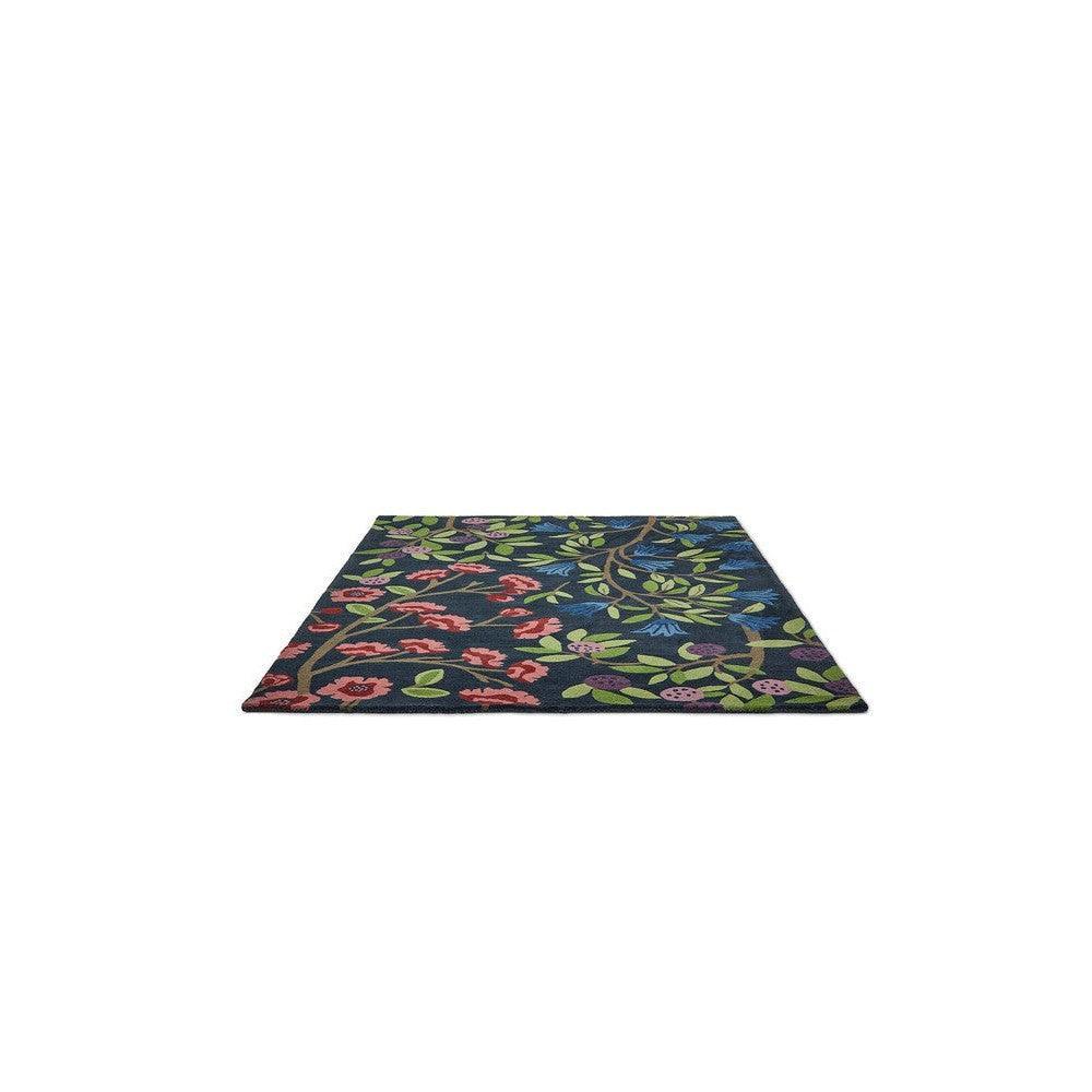 Sanderson Foraging Indigo Rug featuring floral vine pattern in navy, pink, green and blue on indigo background, hand-tufted wool