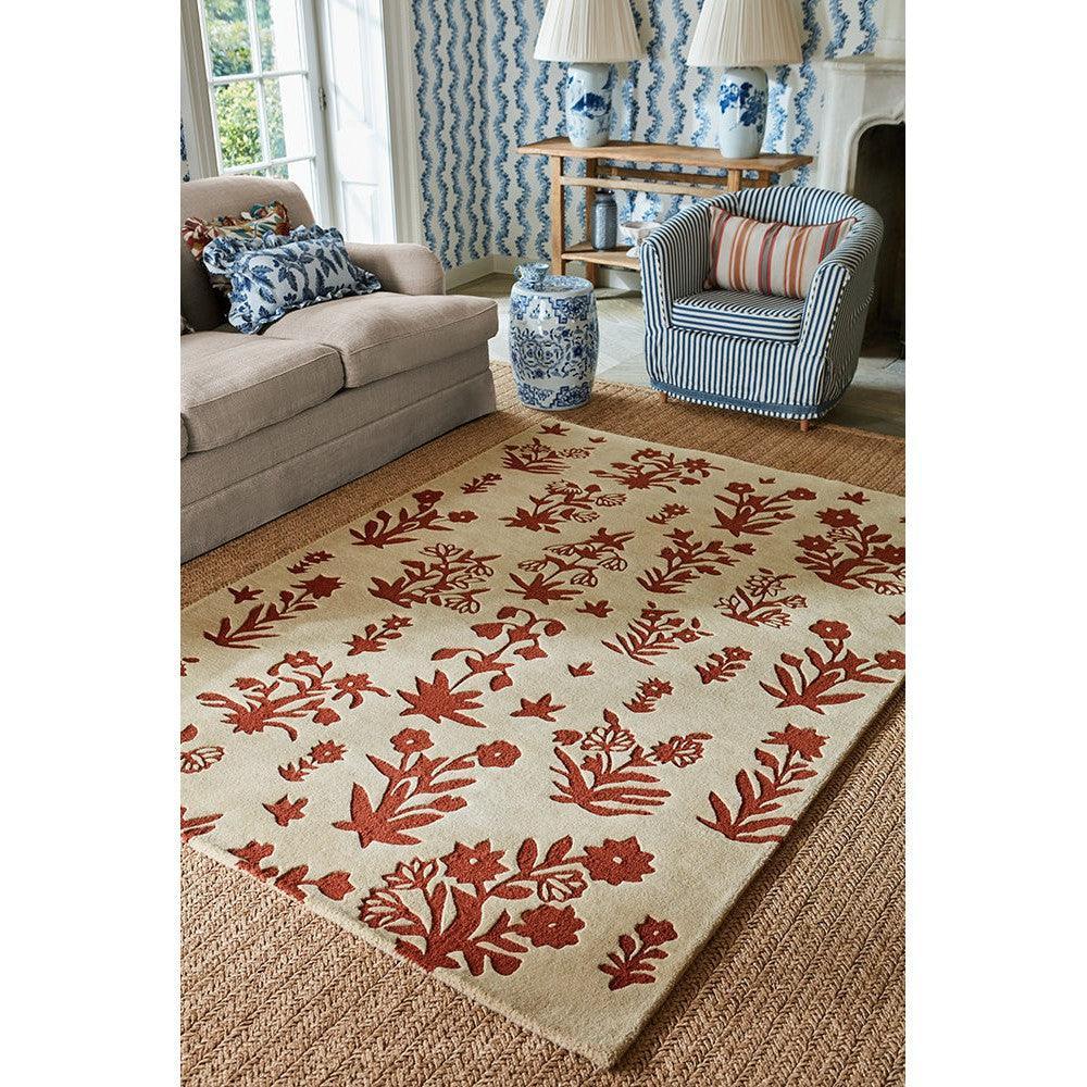 Sanderson Woodland Glade rug featuring botanical floral pattern in russet red on linen beige background, hand-tufted wool