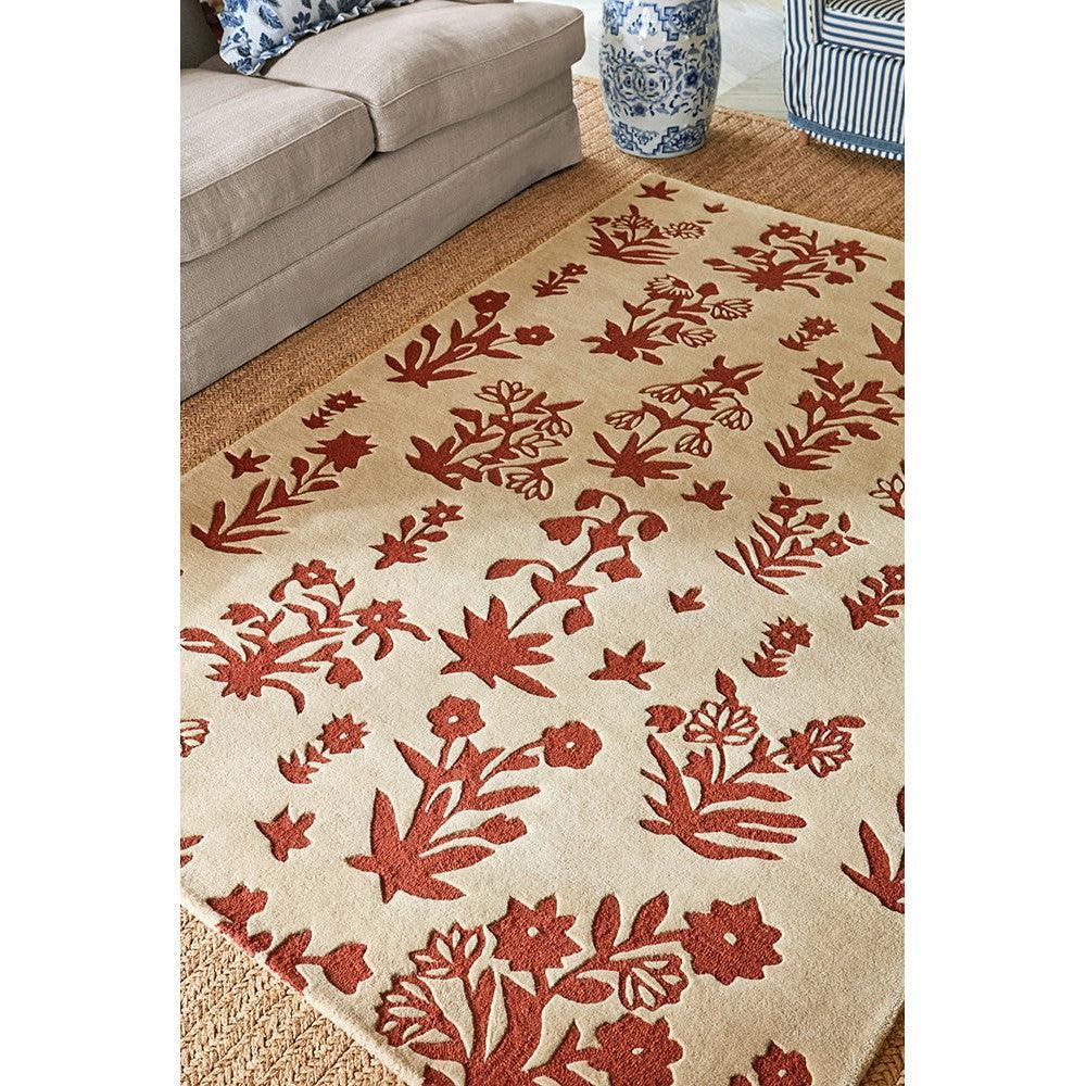 Sanderson Woodland Glade rug featuring botanical floral pattern in russet red on linen cream background, woven wool