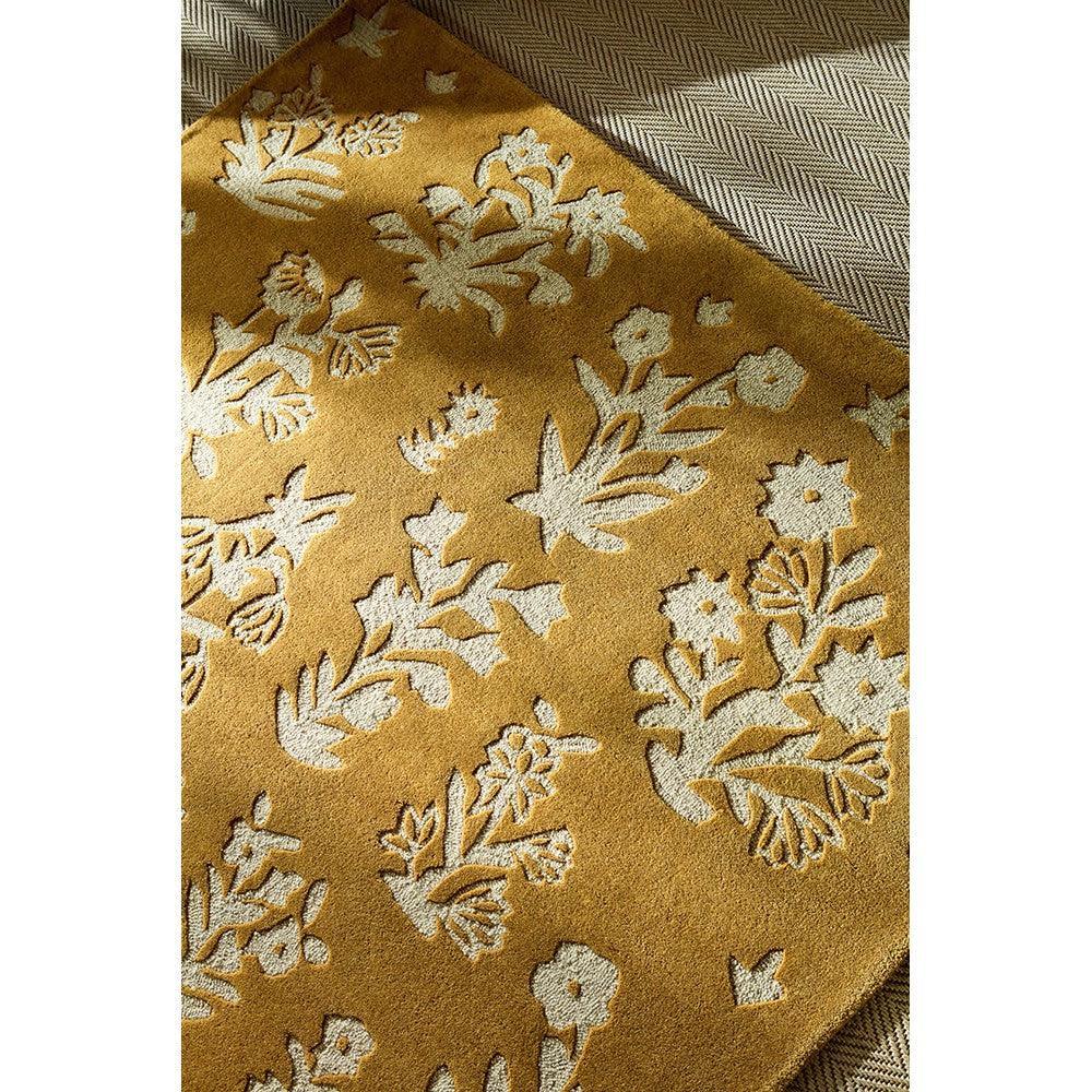 Sanderson Woodland Glade Gold Designer Rug featuring botanical floral pattern in white on gold background, hand-tufted wool