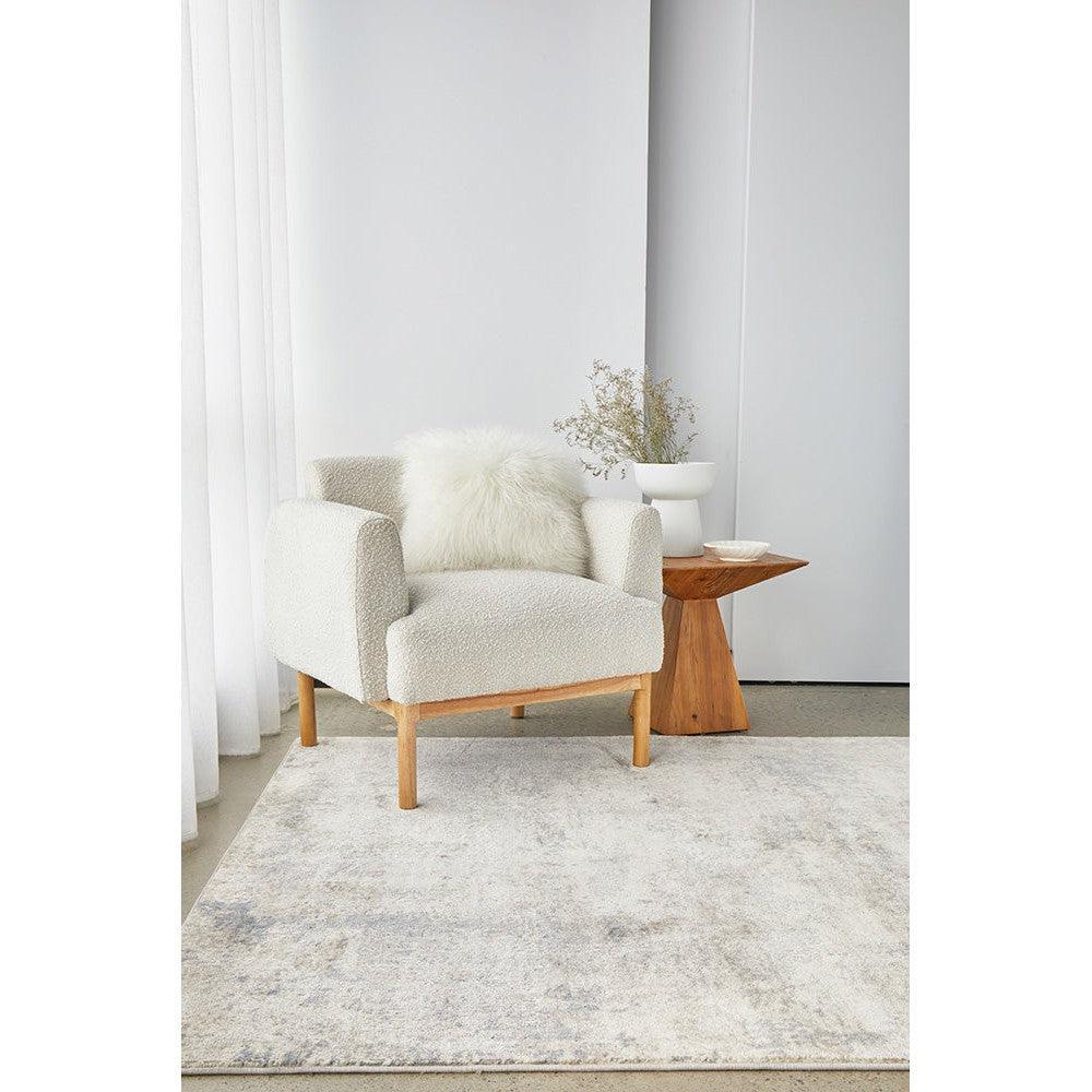 Bronte Aldo Sky Rug featuring distressed pattern in pale blue, ivory and grey on cream background, hand-tufted wool