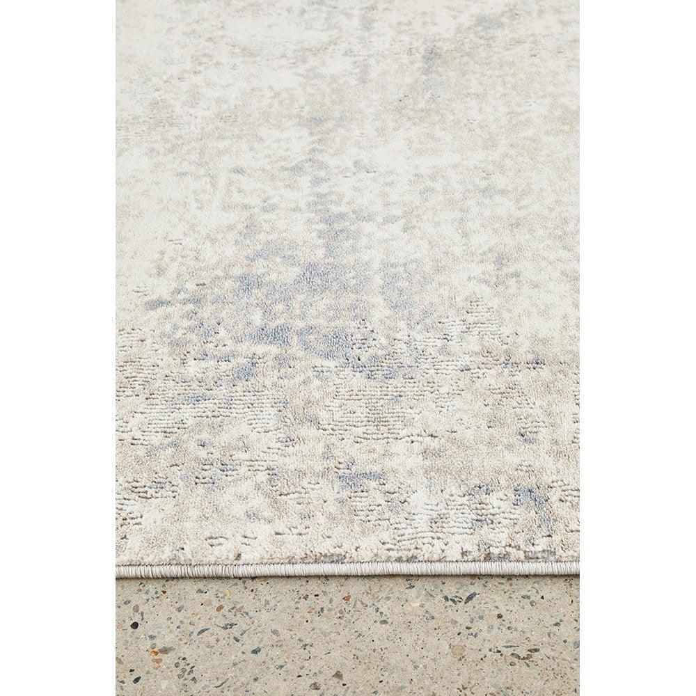 Bronte Aldo Sky Rug featuring abstract pattern in cream, pale blue on ivory background, machine-made wool