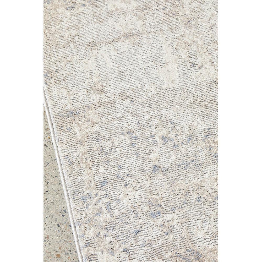 Bronte Aldo Sky Rug featuring distressed botanical pattern in beige, cream and pale blue on ivory background, hand-tufted wool