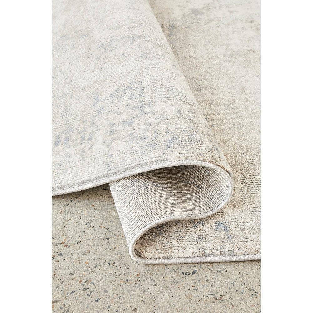 Bronte Aldo Sky Rug featuring distressed pattern in pale beige, sky blue & ivory on cream background, hand-tufted wool