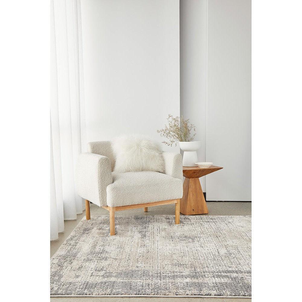 Bronte Ceasar Manor Rug featuring distressed geometric pattern in charcoal grey, ivory, taupe and light grey on cream background, hand-tufted wool