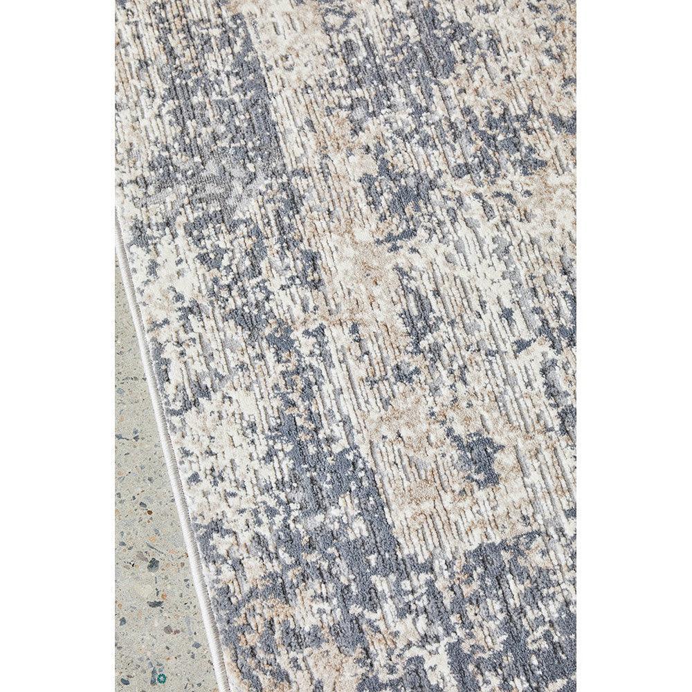 Bronte Ceasar Manor Rug featuring distressed abstract pattern in navy, beige and ivory on light background, hand-tufted wool