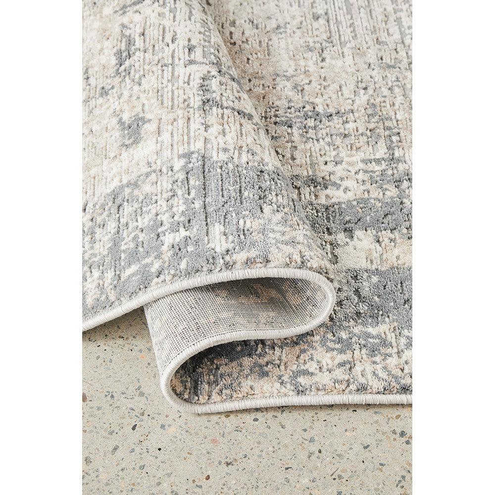 Bronte Ceasar Manor Rug featuring abstract distressed pattern in ivory, cream, taupe and grey on ivory background, machine-made polypropylene