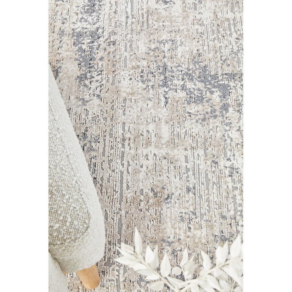 Bronte Nola Powder Rug featuring an abstract distressed pattern in cream, taupe and grey on powder background, hand-tufted wool