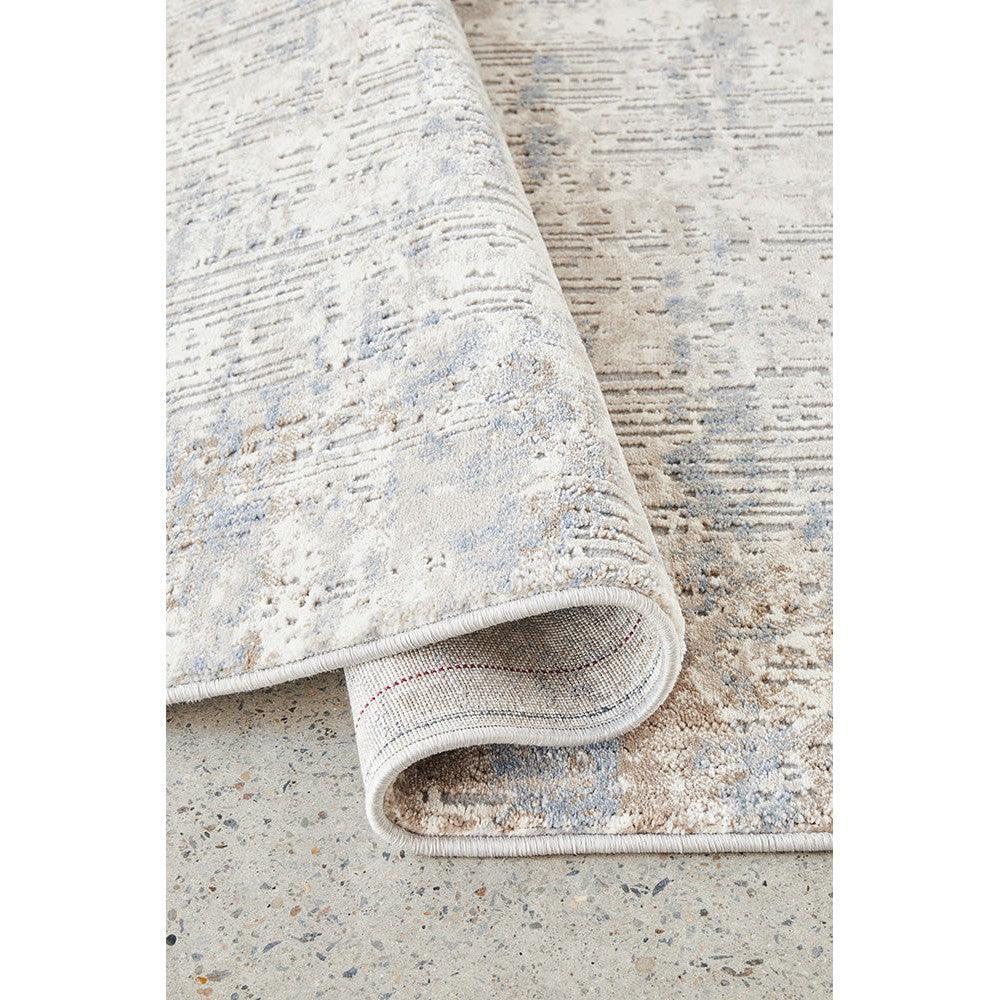 Bronte Nola Powder Rug featuring distressed abstract pattern in cream, pale blue and grey on ivory background, machine-woven wool blend