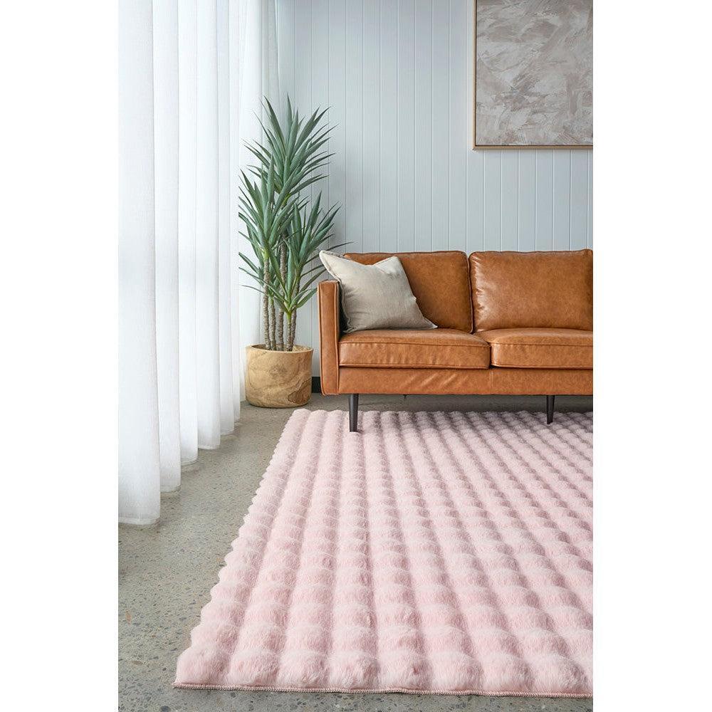Bubble Blush rug featuring bubble-textured design in soft pink on light grey floor; machine-washable synthetic fibre