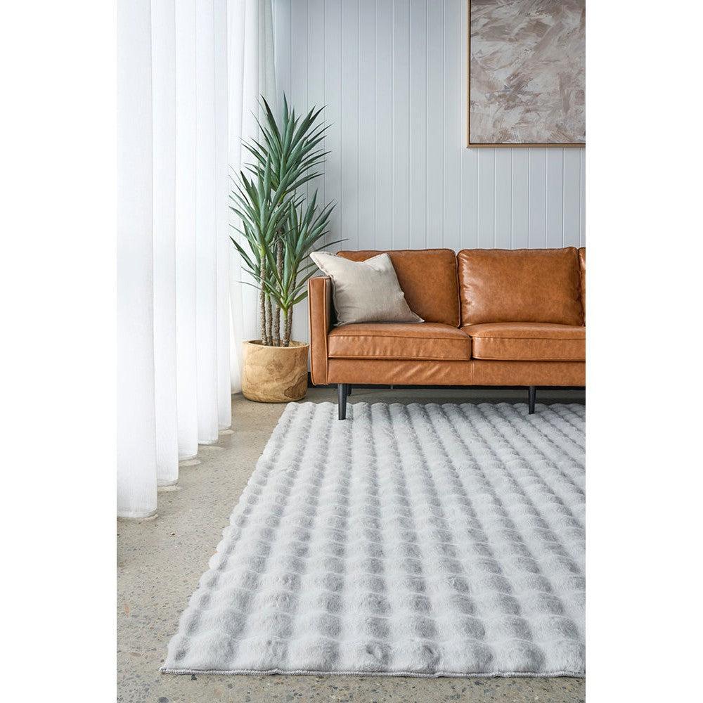 Bubble Silver rug featuring bubble texture in ivory, light grey and pale silver on light blue backdrop, machine-washable polyester