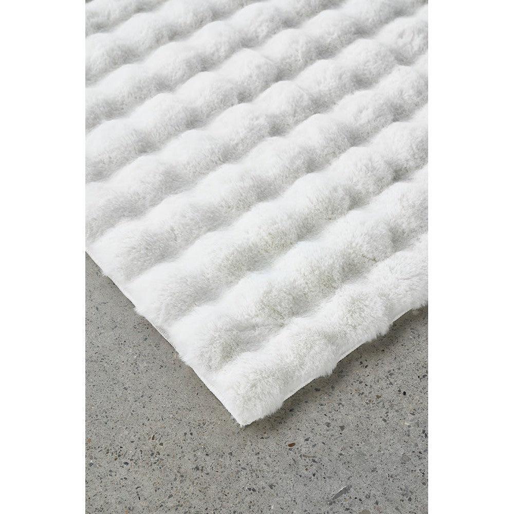 Bubble White rug featuring bubble tuft pattern in bright white on light grey background, machine-washable plush synthetic