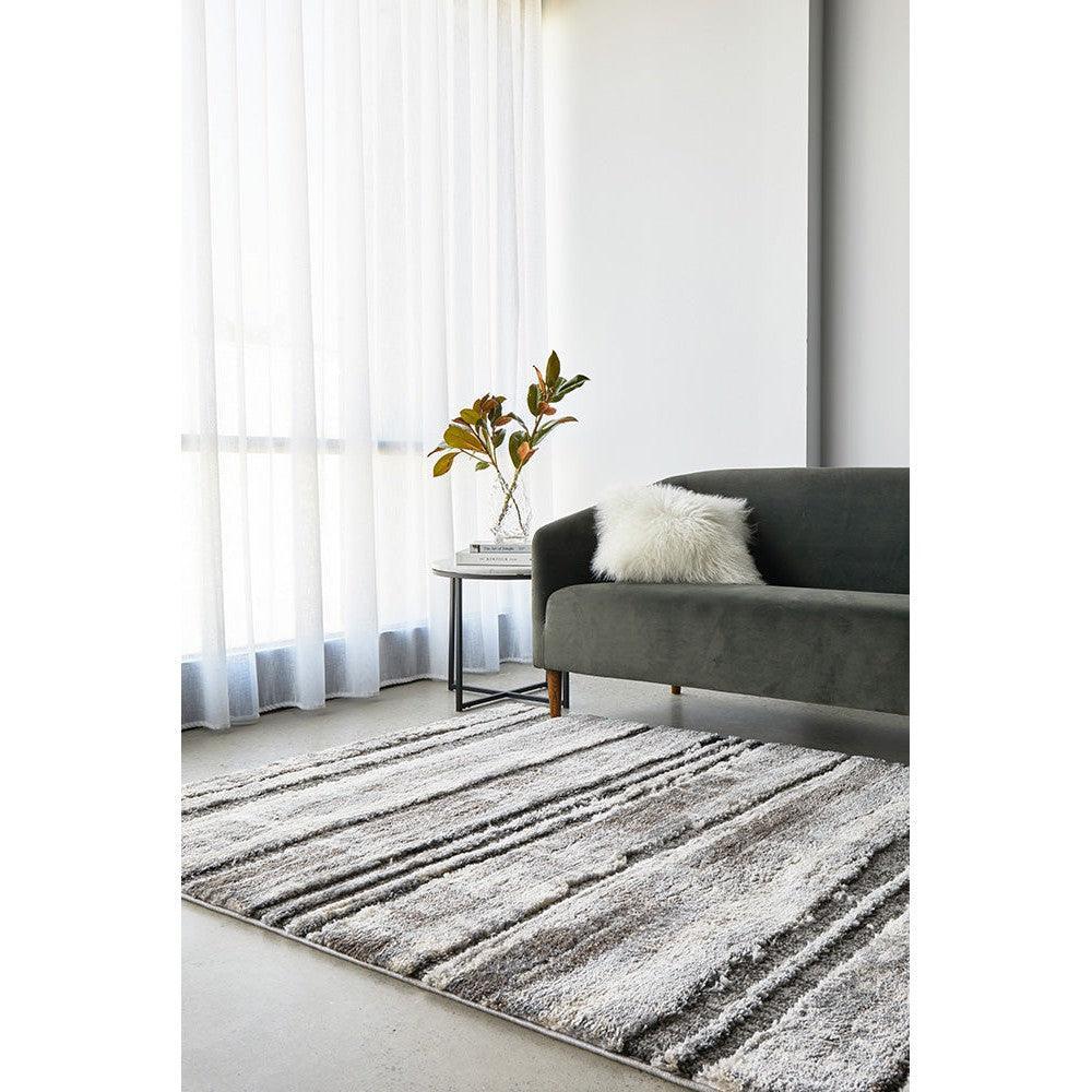 Himali Baley Slate Rug featuring abstract striped pattern in slate grey, charcoal, ivory on light beige background, hand-tufted wool