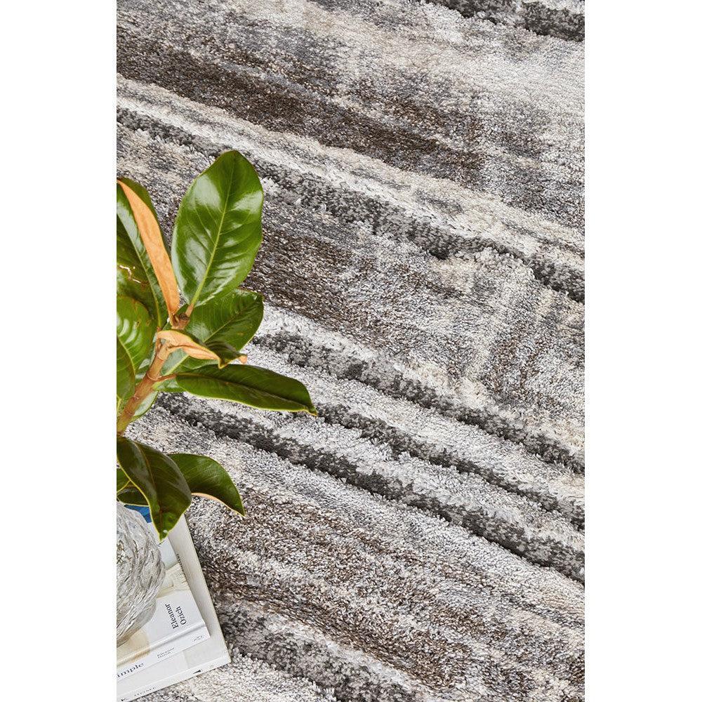 Himali Baley Slate Rug featuring textured striped design in slate grey, charcoal and ivory on light grey background, hand-tufted wool