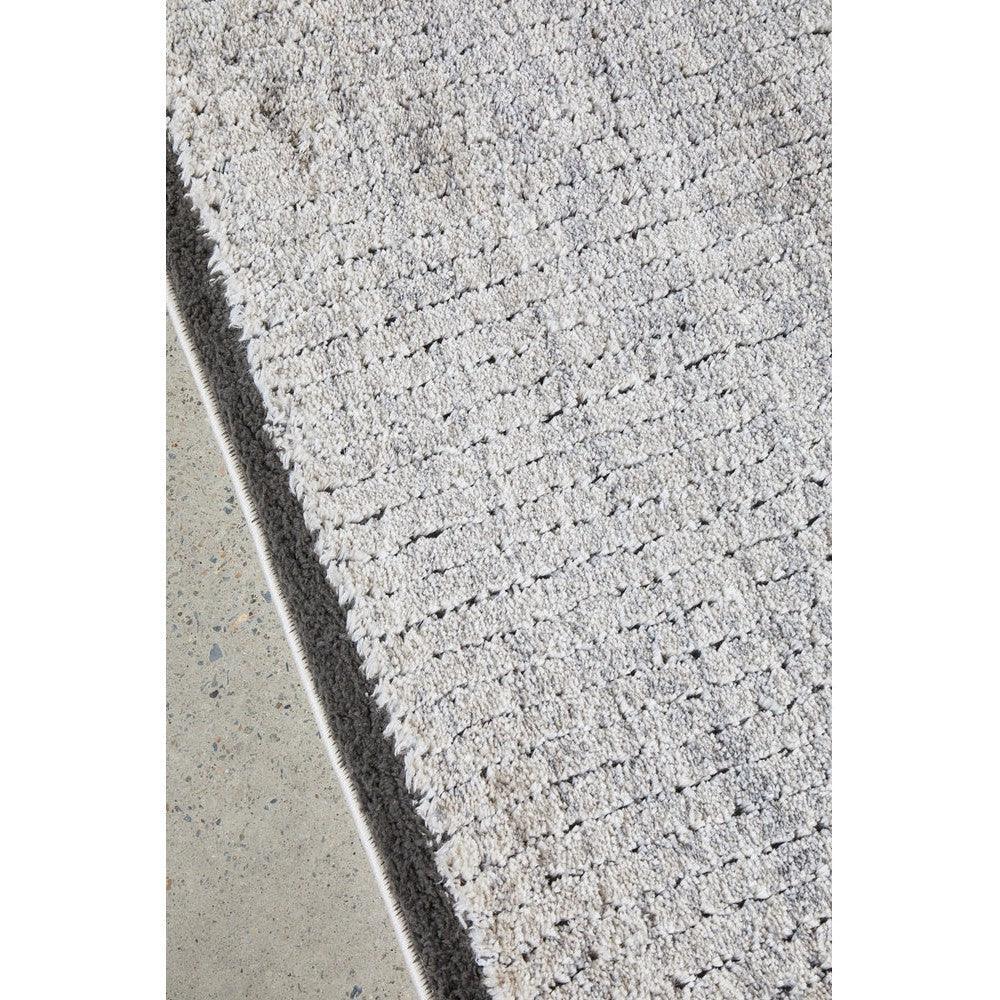 Himali Charlie Pewter Rug featuring textured shag pattern in pewter grey on light concrete background, hand-tufted wool