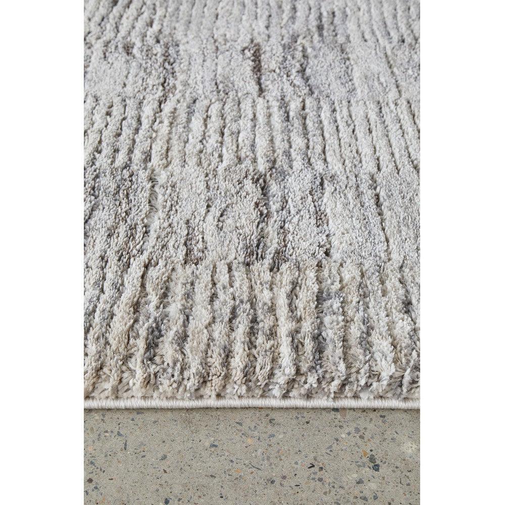 Himali Fin Steel Rug featuring shaggy pile in steel grey and ivory on a light grey background, machine-made shaggy pile rug