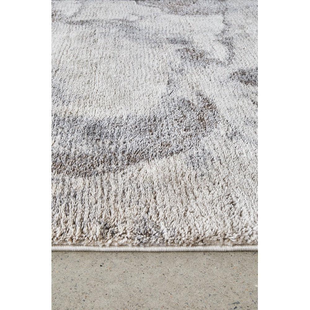 Himali Pedro Storm Rug featuring abstract shag pattern in storm grey, charcoal, ivory and beige on cream background, hand-tufted wool