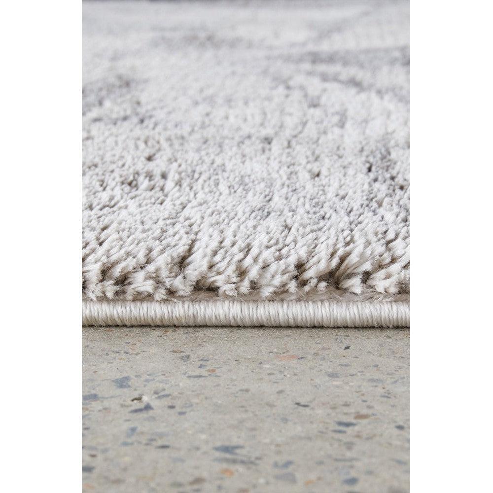 Himali Pedro Storm Rug featuring shaggy pile in storm grey and ivory on light cream background, hand-tufted wool
