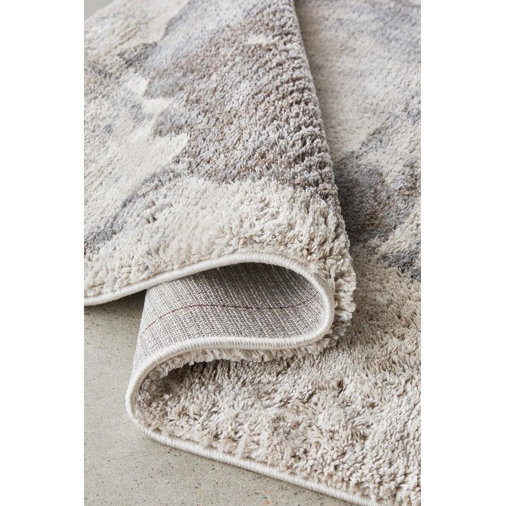 Himali Pedro Storm Rug featuring abstract marbled pattern in cream, beige, taupe and grey on light grey background, hand-tufted wool