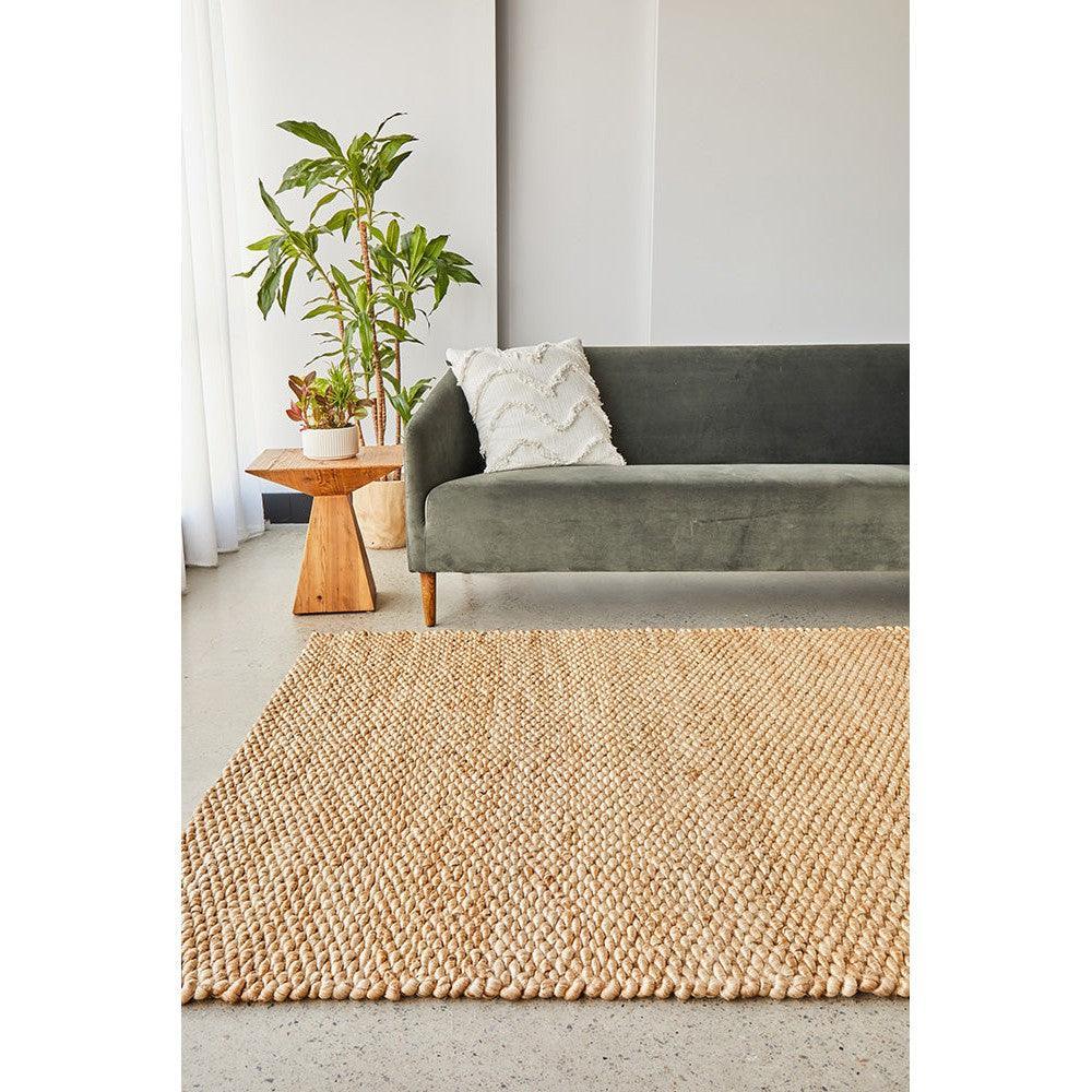 Hive Natural Rug featuring chunky woven texture in natural beige and tan on light grey background, hand-woven jute