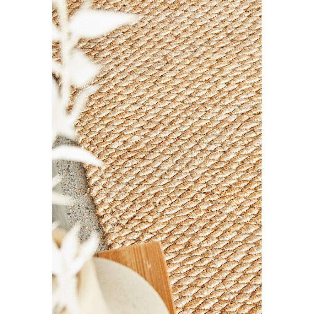 Hive Natural Rug featuring braided rope weave in natural beige, tan on cream background, hand-woven jute