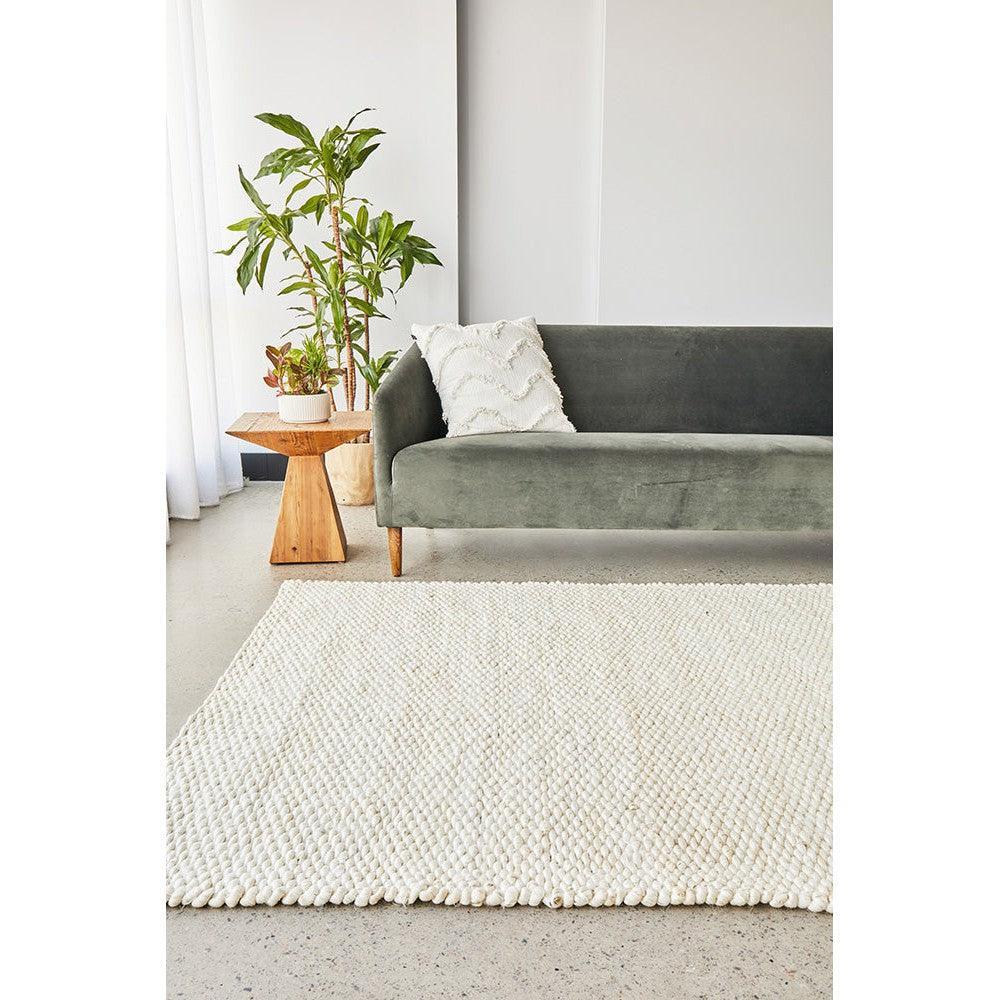 Hive White Rug from Hive Collection featuring chunky boucle weave in white on light background, hand-woven wool