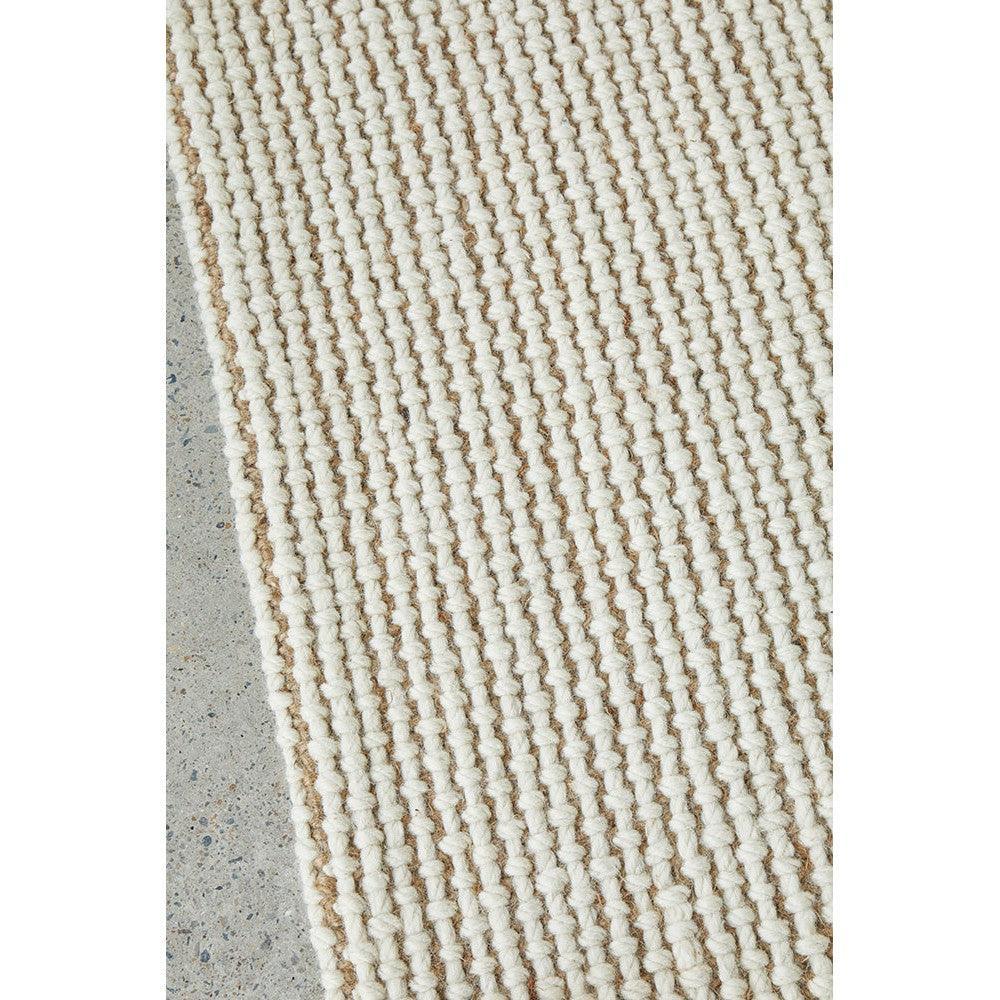 Harlow Cove Cream Rug featuring chunky rope-knit pattern in cream and beige on pale concrete background, hand-woven cotton