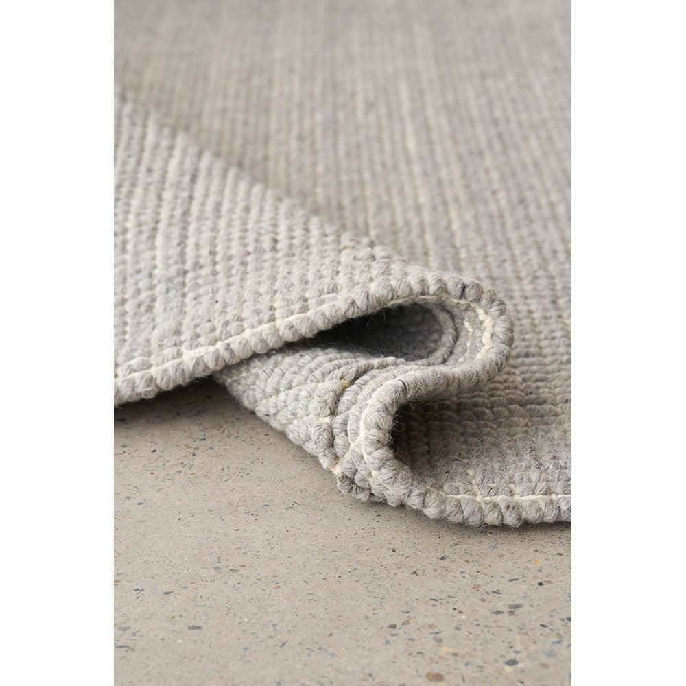 Madras Parker Dove Wool & Jute Rug featuring textured plain weave in dove grey on concrete grey background, woven wool & jute