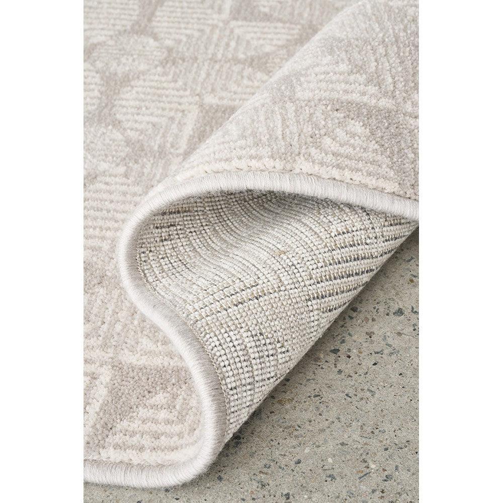 Prague Niko Silver Rug featuring geometric pattern in silver, ivory and taupe on pale grey background, machine-loomed wool blend